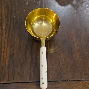 Gold Measuring Cup with White Handle